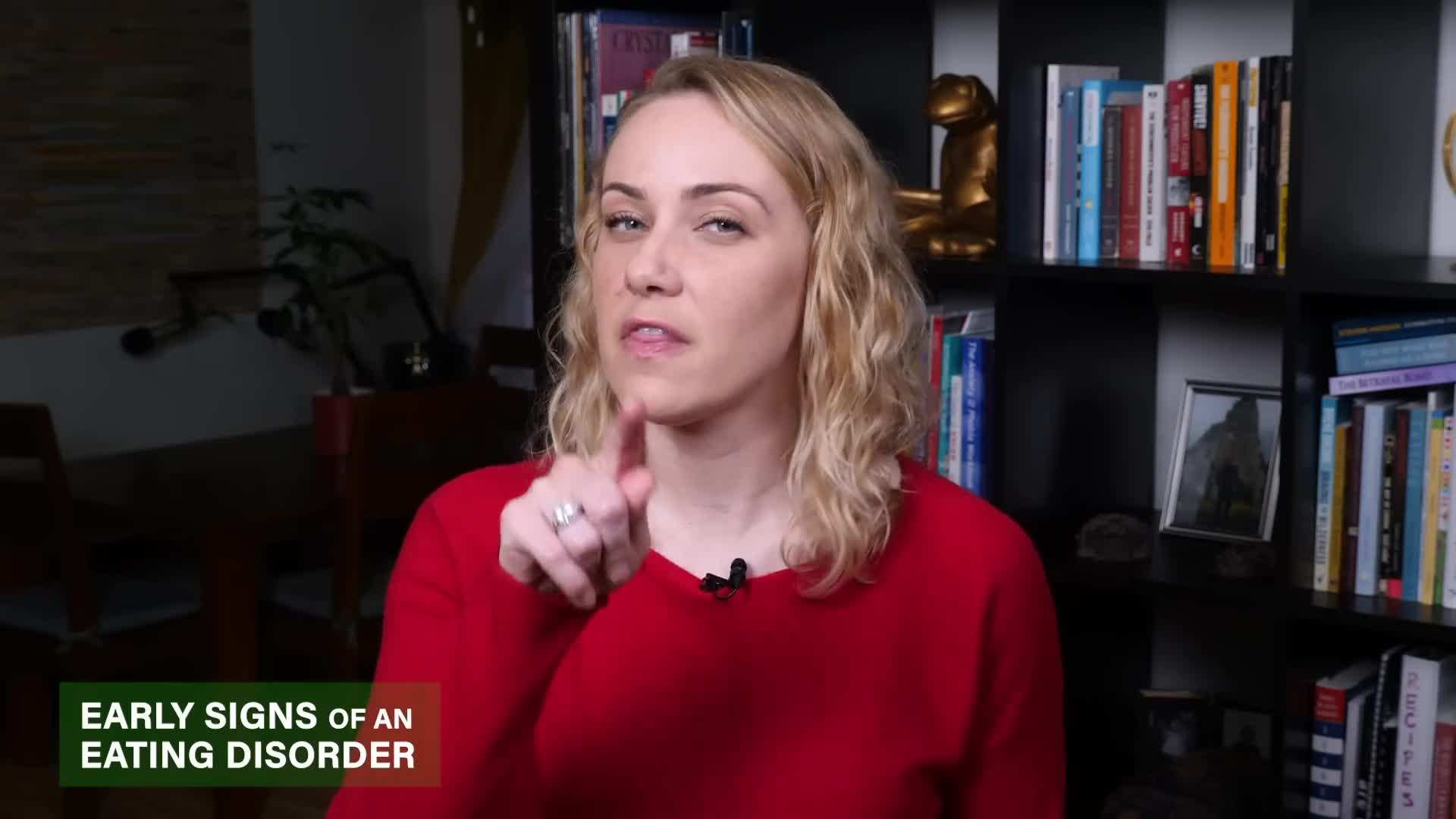 Illustration: A person looking distressed while staring at a scale