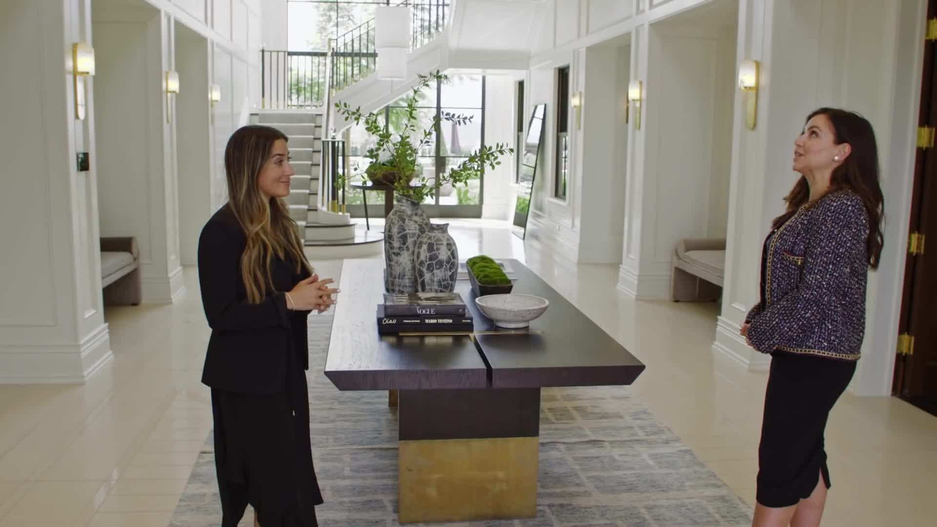 The double-height foyer with a sweeping staircase