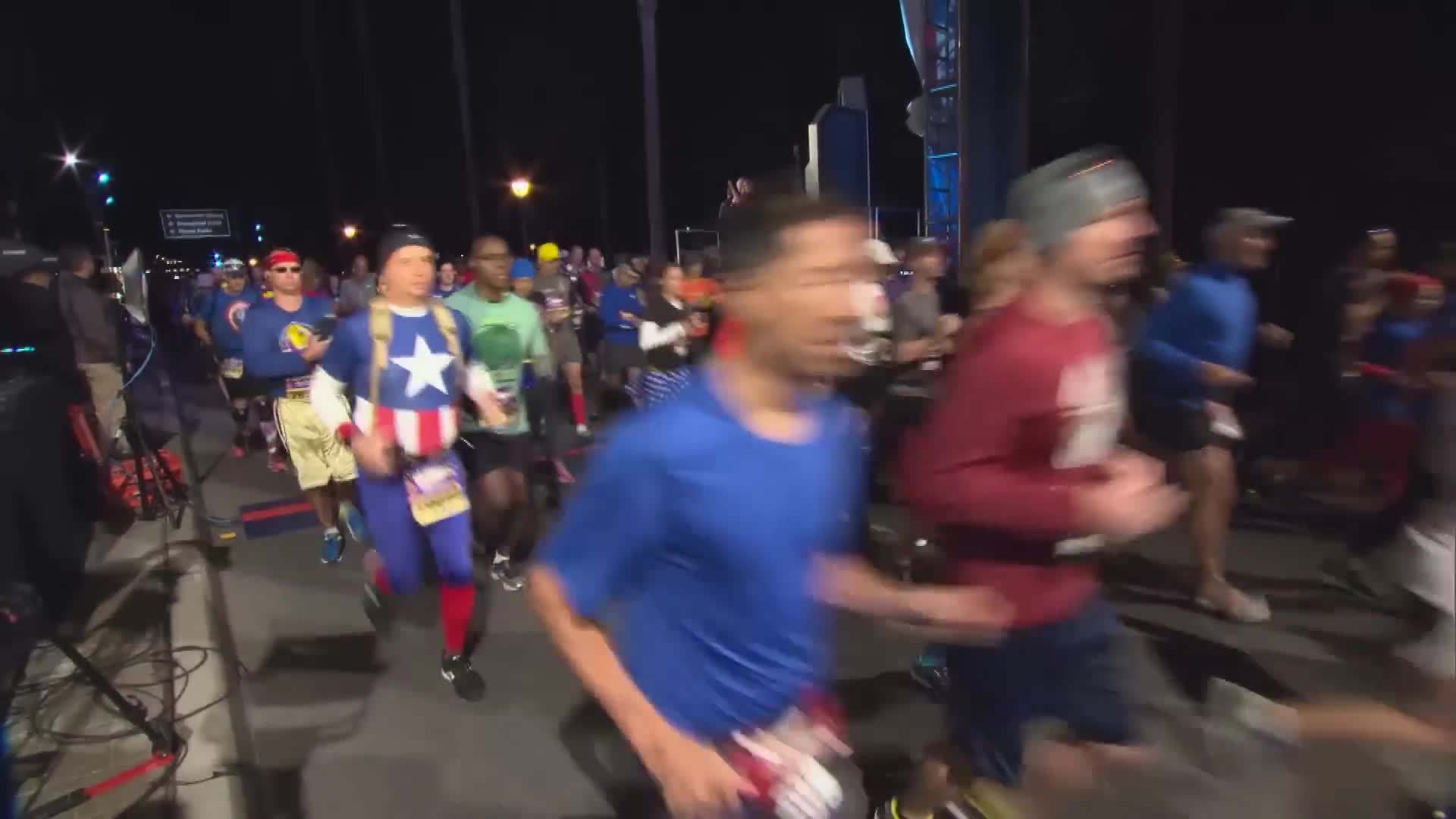 runDisney participants running through Cinderella Castle