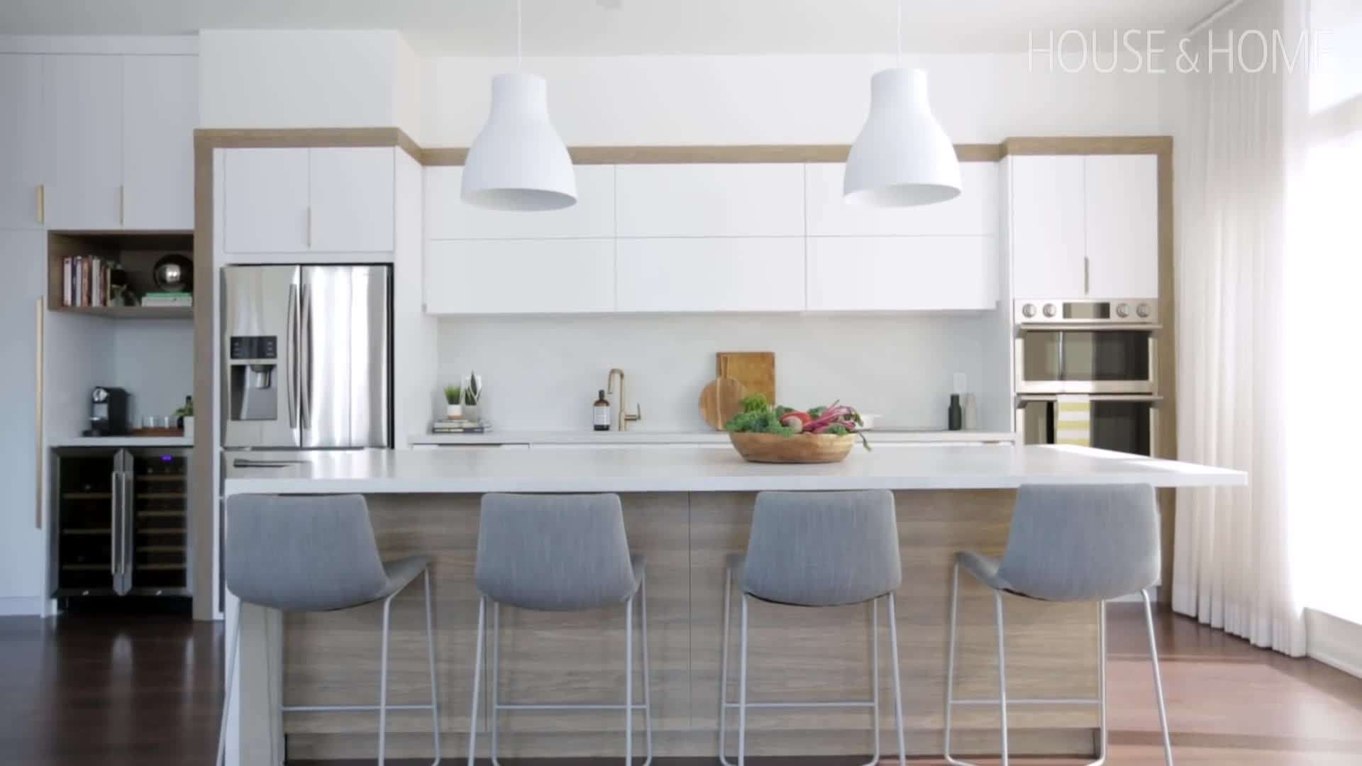 Close-up of the white matte cabinet fronts and brass pulls