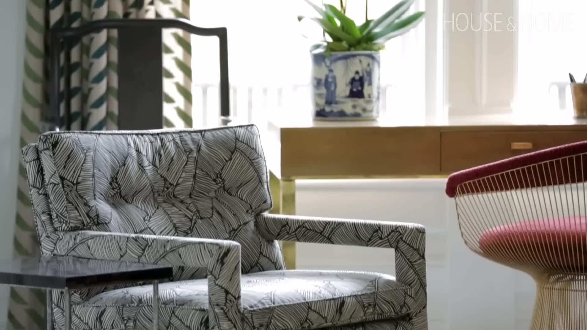 The dining room with lacquered chairs and whimsical drawings on the walls