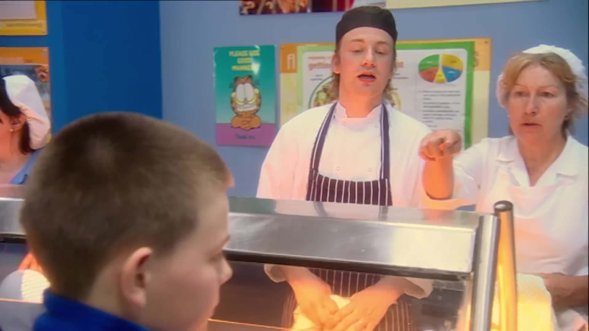 Jamie serving his food to children
