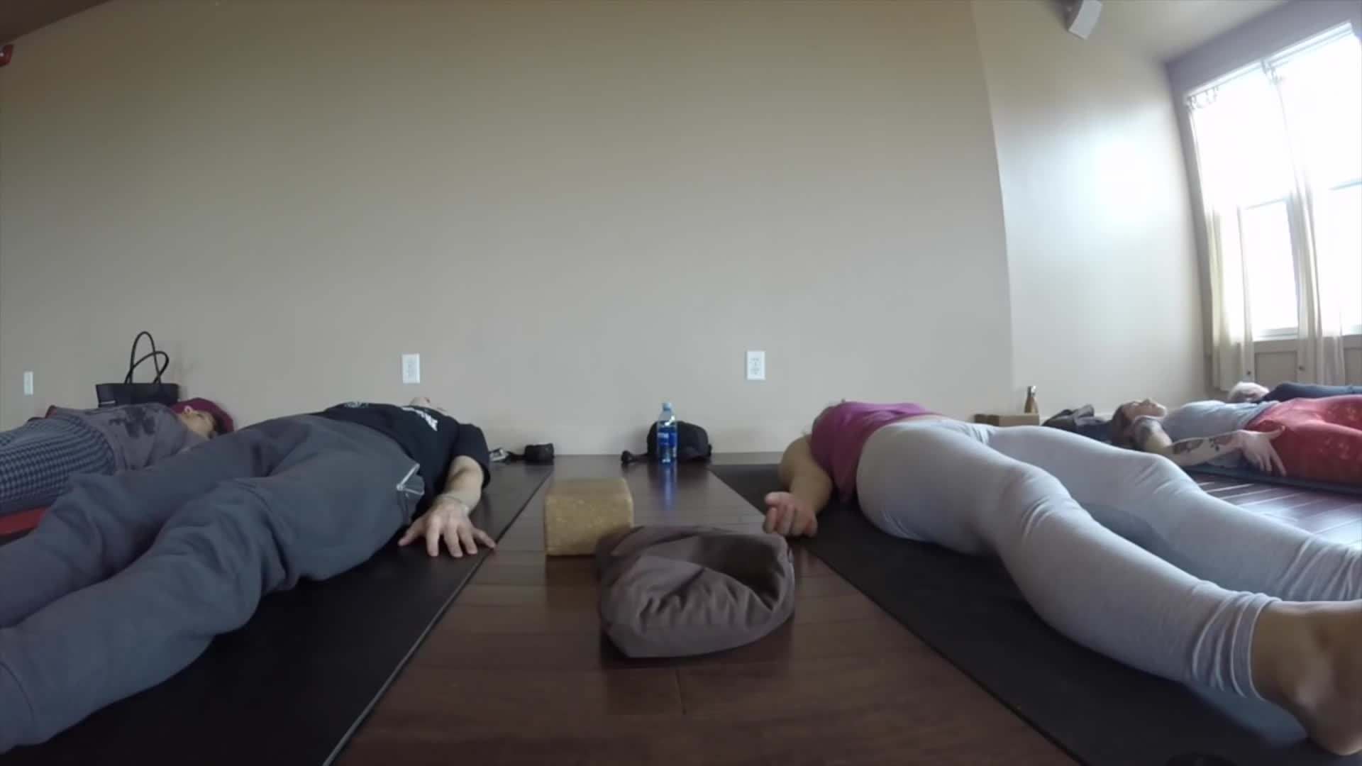 Practicing yoga at the Sattva Yoga Studio