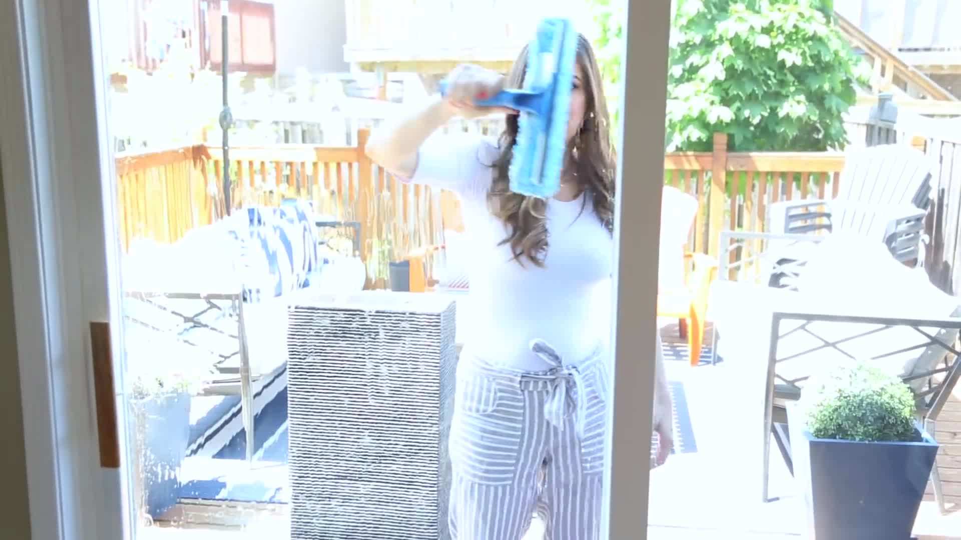 Cleaning outdoor windows with a high-pressure hose