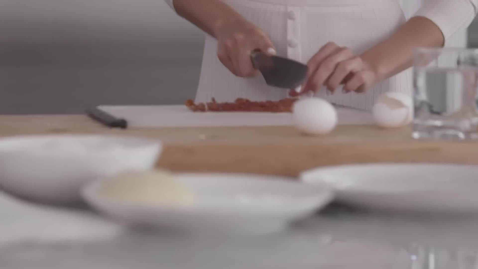 Adding scrambled eggs to the pizza