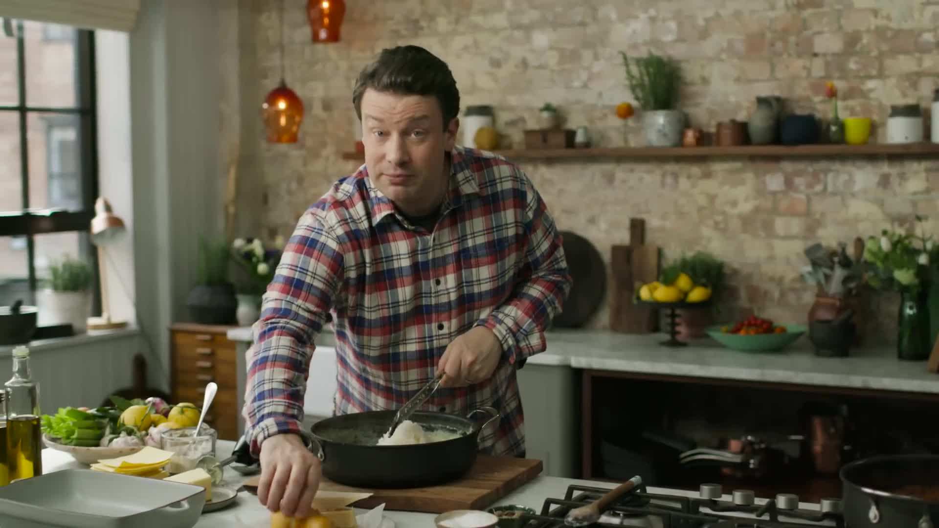 Layering cheddar and mozzarella cheese in the sauce