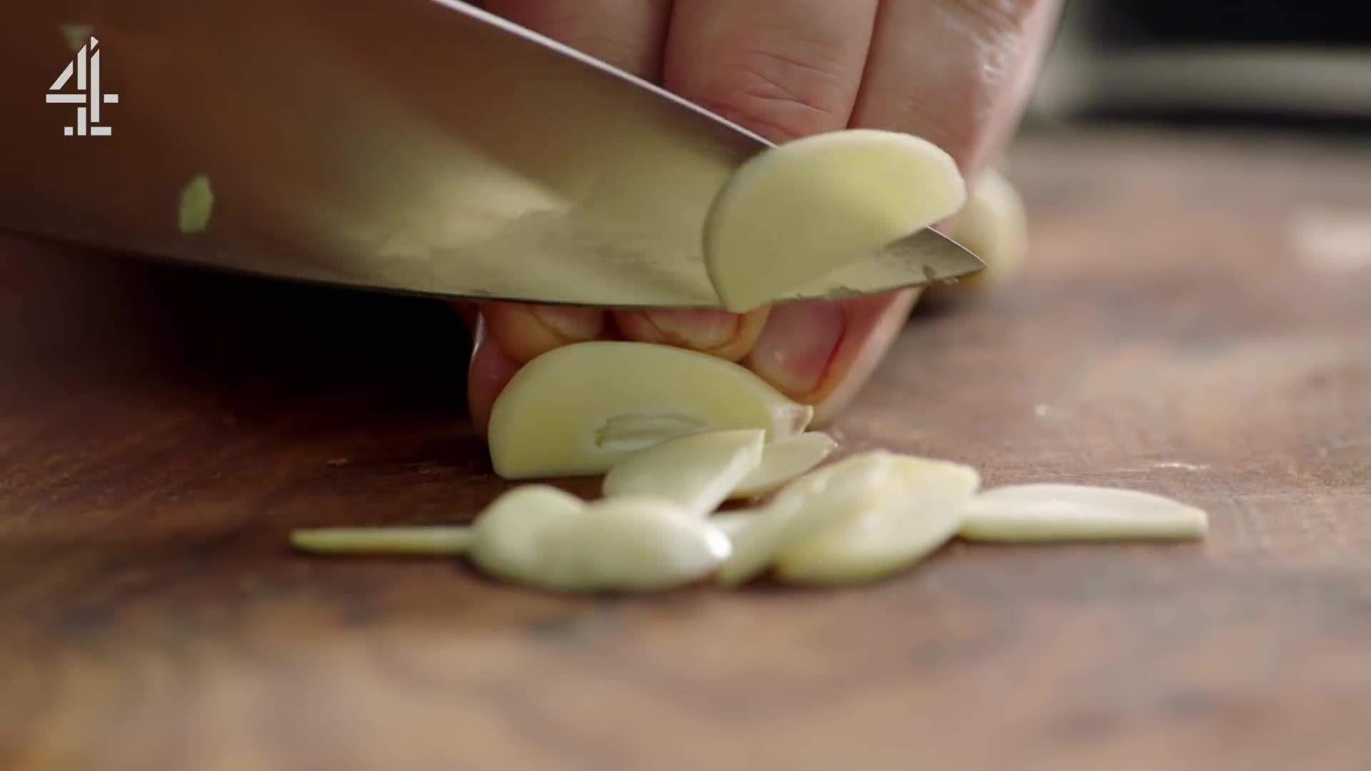 Slicing garlic into evenly sized pieces