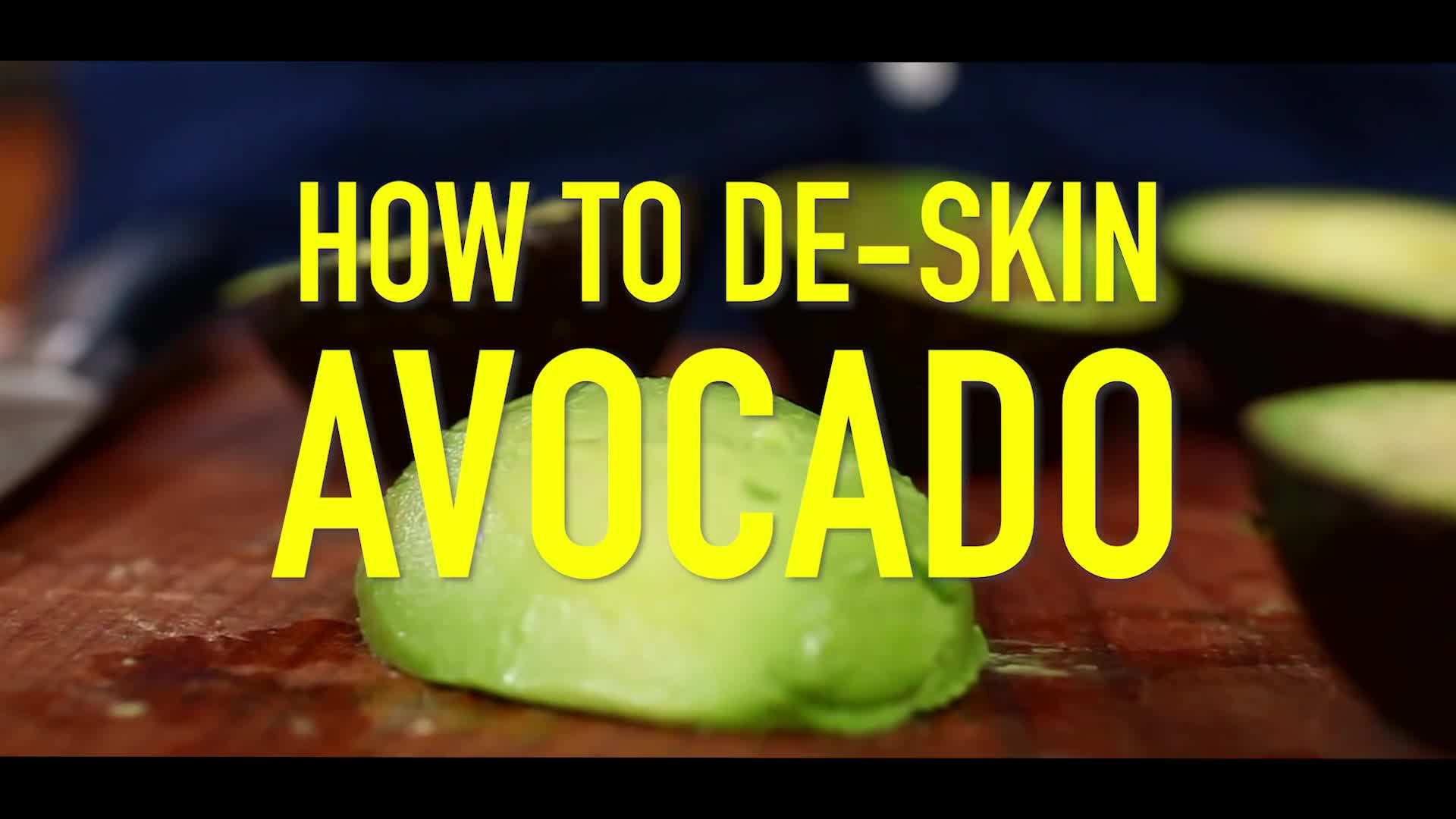 Using a spoon to remove the avocado seed