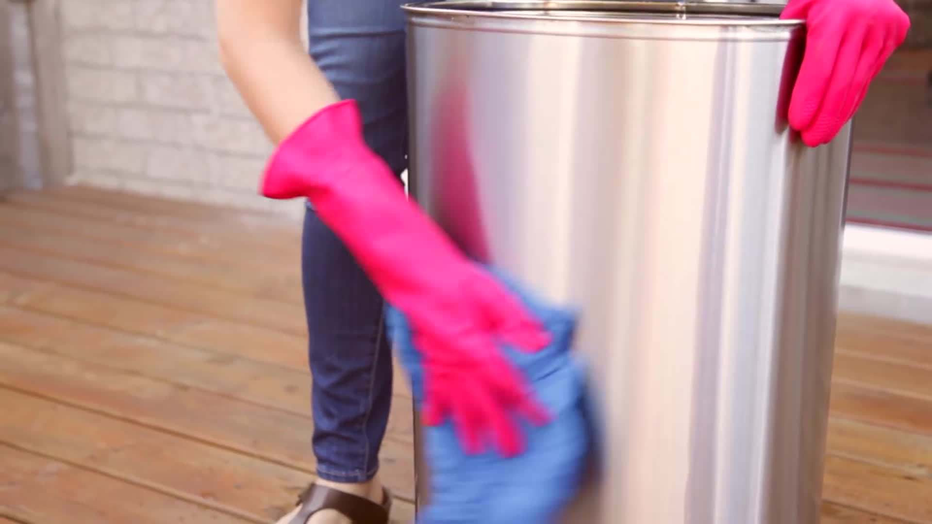Scrubbing the garbage can with a sponge
