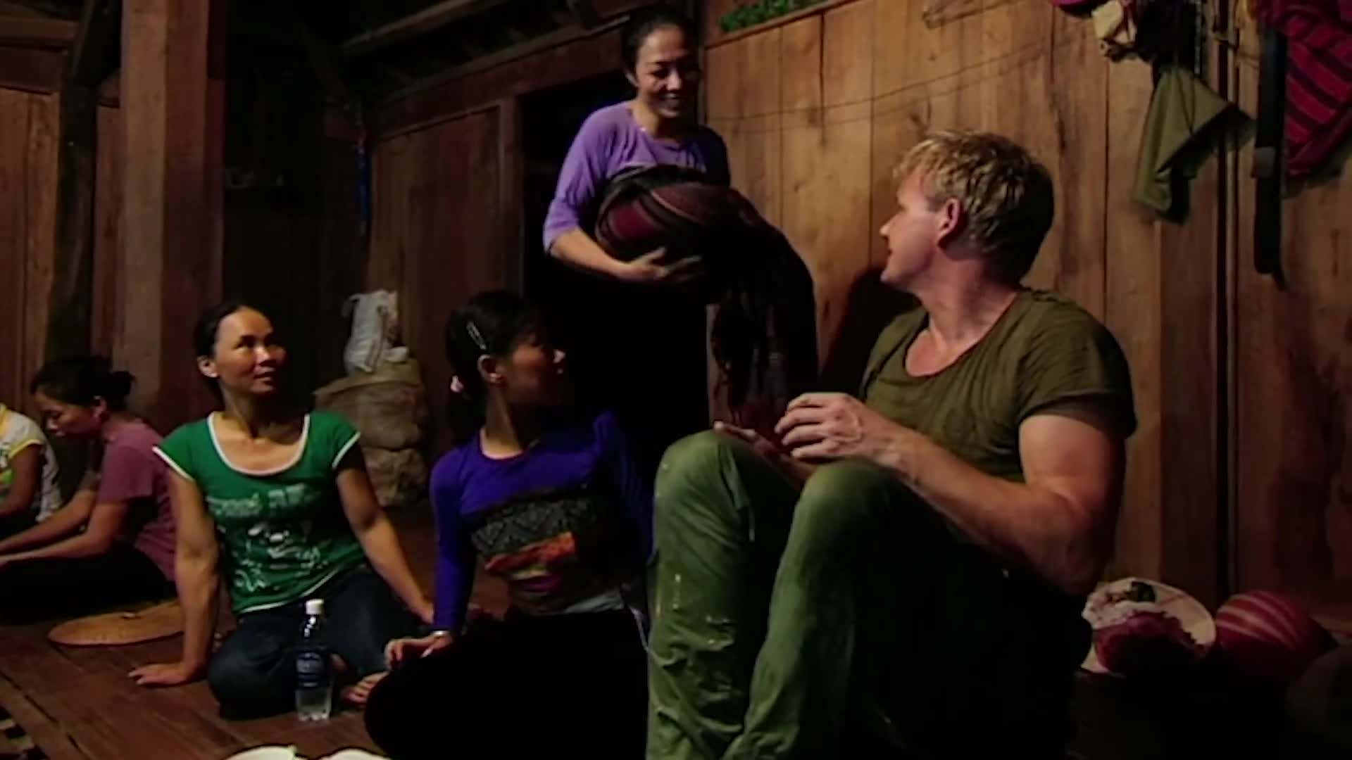 Gordon Ramsay serving food at the rice harvest celebration